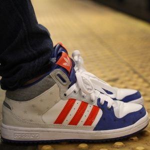 Adidas orange, white, and blue sneakers